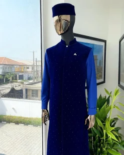 The “orunmila” navy blue Trench soaked Italian velvet traditional jacket with black Swarovski stones detailing, matching hat, cobalt blue Senator kaftan & pant trousers.