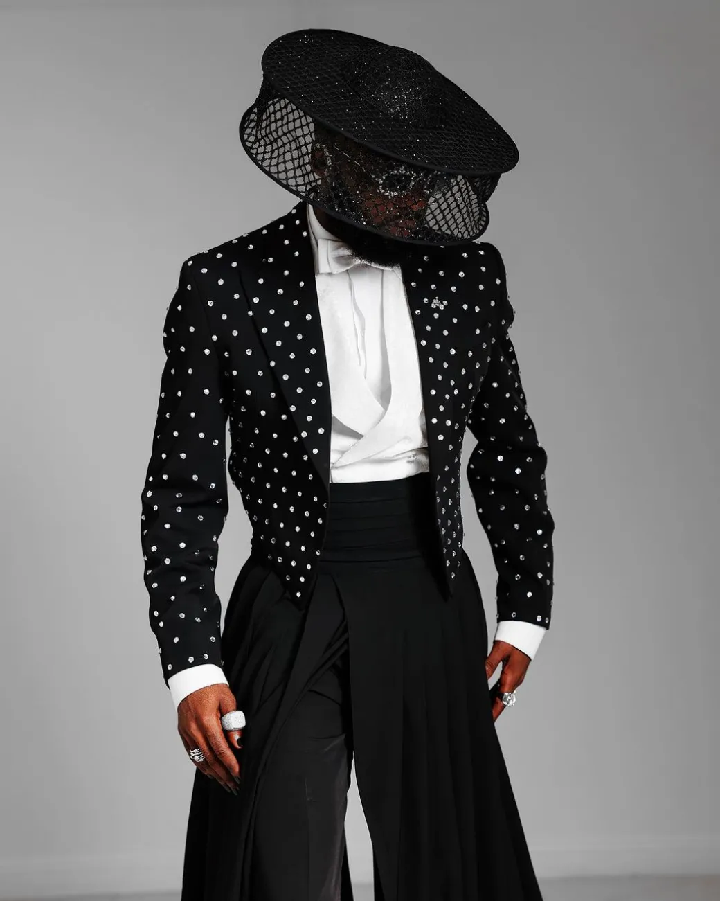 The ”Prince” Charcoal Black Short Peak Lapel Suit With ss30 Swarovski Stones, Double-breasted Waistcoat, High Pant Trousers & Pleated Long Tail Skirt.
